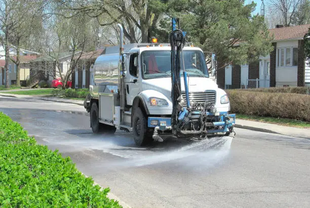 Lifestyle...This shot shows a springtime theme. A "pumper truck" passes through a quiet suburban neighborhood, and washes away winter's salt and dirt.