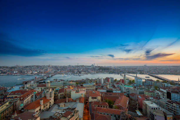istock Long exposure panoramic cityscape of Istanbul at a beautiful dramatic clouds sunset from Galata to Golden Horn gulf. View of the wonderful romantic old town at Sea of Marmara. Istanbul. Turkey. 957790950