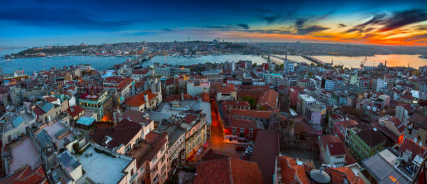istock Long exposure panoramic cityscape of Istanbul at a beautiful dramatic clouds sunset from Galata to Golden Horn gulf. View of the wonderful romantic old town at Sea of Marmara. Istanbul. Turkey. 957790970