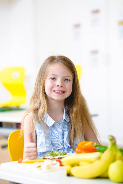 istock Happy pupil prepare a healthy snack for the break 957791932