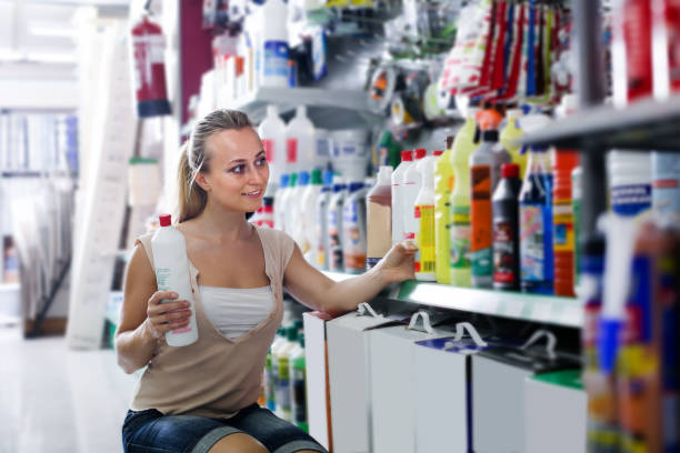 istock happy young woman customer choosing paint medium in bottle in hypermarket 957793142