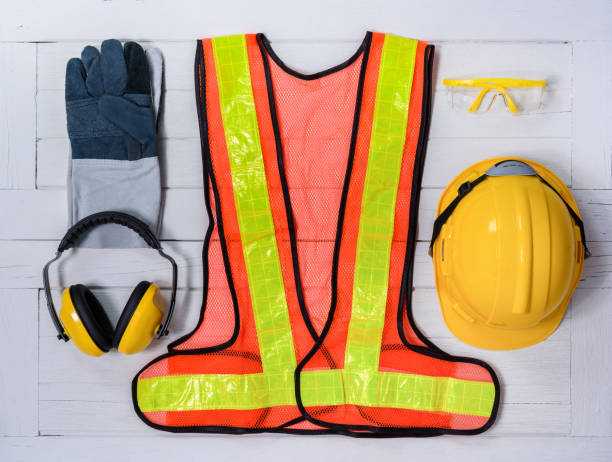 istock Standard construction safety equipment on wooden table. top view 957796674