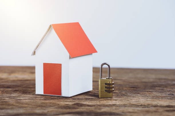 istock Paper house model with metal security lock with pass-code or password, saving money for real estate 957797646