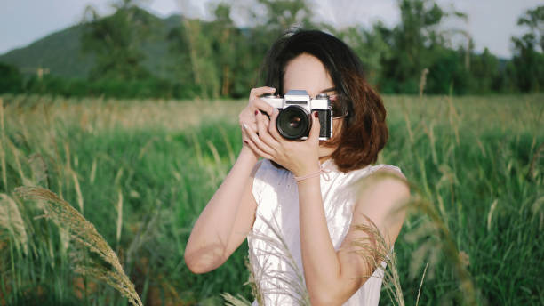 istock Woman using DSLR camera film. 957797836