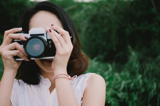 istock Woman using DSLR camera film. 957797852