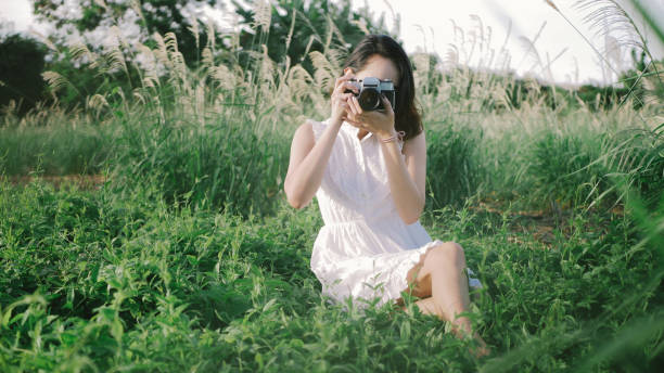 istock Woman using DSLR camera film. 957797854