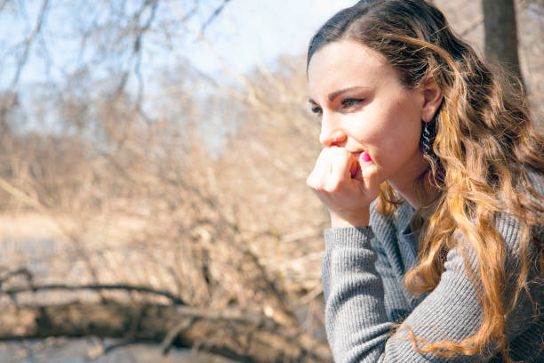istock Smiling young woman by lake. 957801328