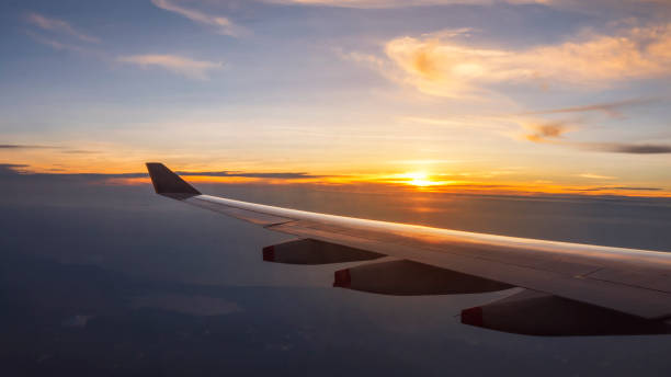 istock Wing of airplane fly over the blue sky and white cloud 6 957805932