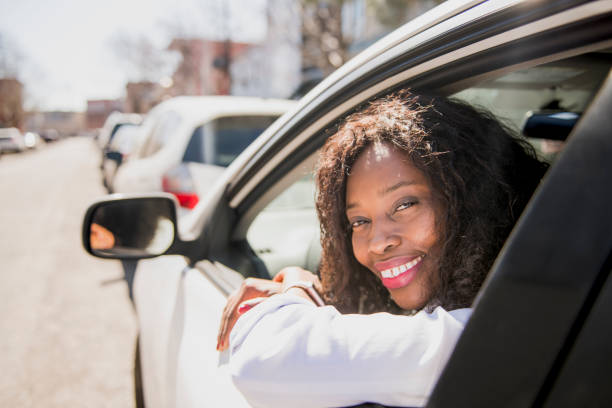 istock Black Business woman on a white car 957811278