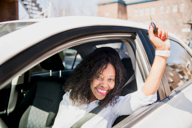 istock Black Business woman on a white car 957811328
