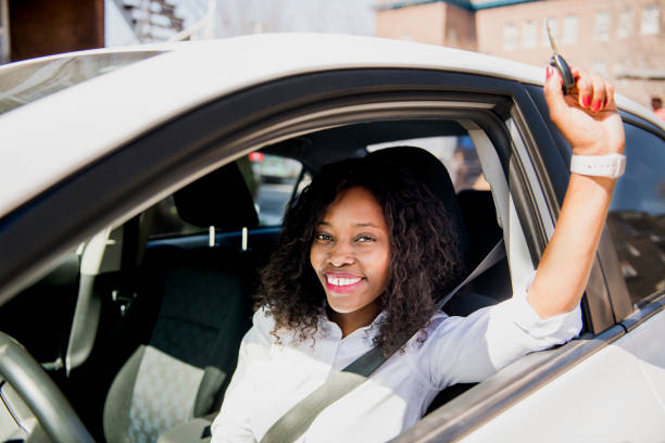 istock Black Business woman on a white car 957811352