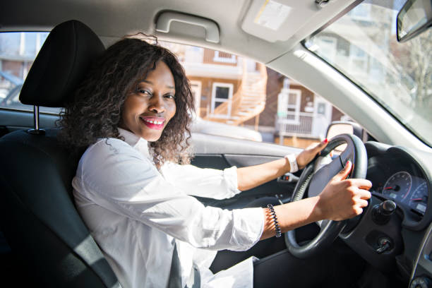 istock Black Business woman on a white car 957811400