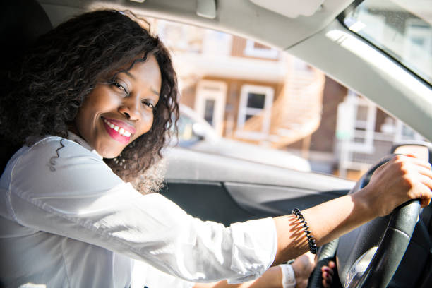 istock Black Business woman on a white car 957811406