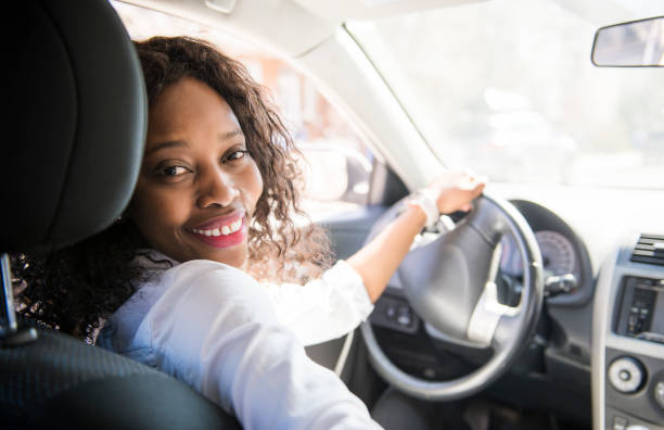 istock Black Business woman on a white car 957811498