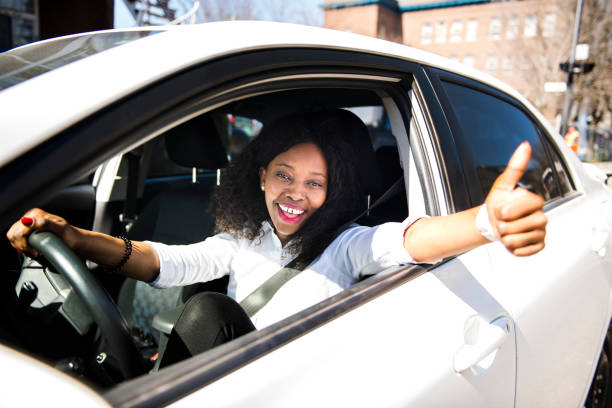 istock Black Business woman on a white car 957811564