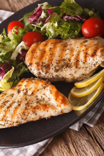 istock Grilled chicken breast with mixed salad close-up. Vertical 957815754