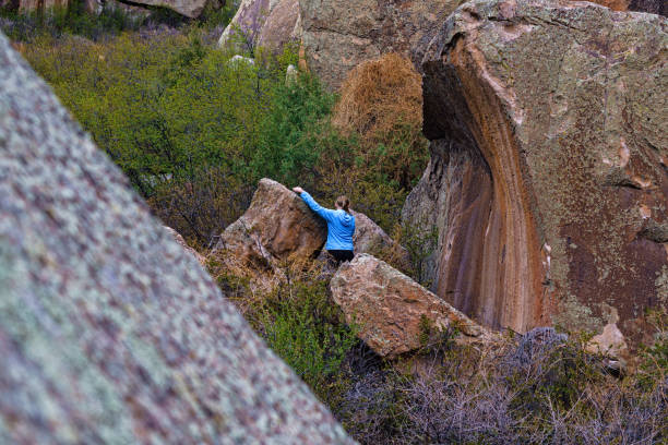 Rock Climbing and Bouldering Penitente Canyon - Girl on rocks scrambling and climbing. Scenic sport climbing canyon and woman climber.