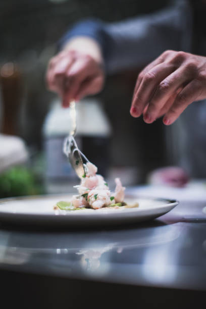 istock Cook preparing northern prawns and salad. Restaurant and caterer in Canada 957820866