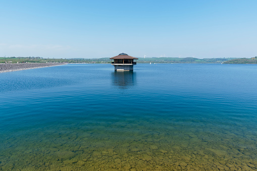 Out in the clear ripples water of Carsington Reservoir, in Derbyshire, stands a hexagonal water control tower.