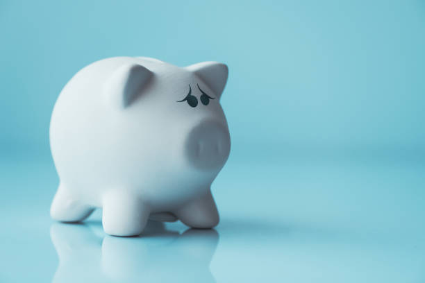 istock Unhappy piggy coin bank 957821130