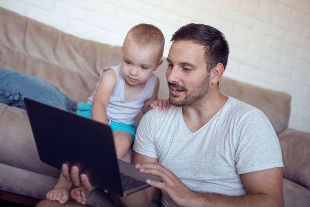 istock Father and son playing at home 957832926