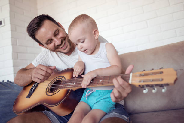 istock Father and son playing at home 957832946