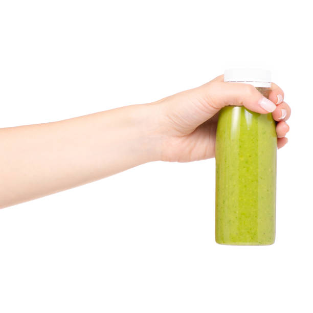 istock Bottle of smoothies green in hand 957834050