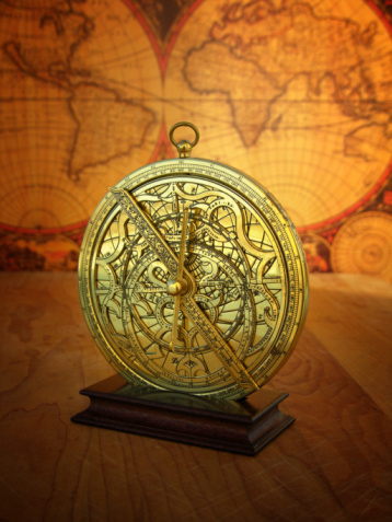 Still life of astrolabe instrument in front of antique world map.  The astrolabe was invented in 170 B.C. and used for navigational computations and astronomical calculations.  Modern surveying and navigational instruments are based on the astrolabe.  Click the thumbnail to see a lightbox of other instruments of measurement: