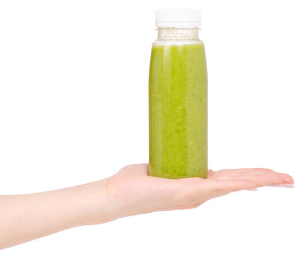 istock Bottle of smoothies green in hand 957838366