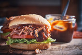 Messy Pulled Pork Burger with Barbecue Sauce and Fresh Salad
