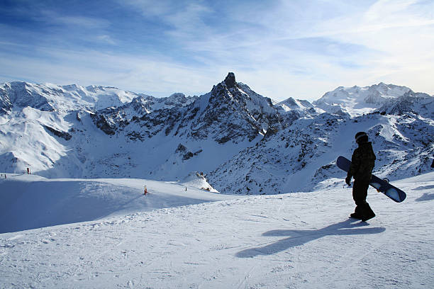 Snowboarder on mountain in Courchevel, France  courchevel stock pictures, royalty-free photos & images