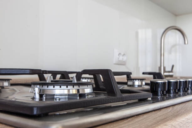 istock Closeup of stove top integrated into kitchen counter 957846494