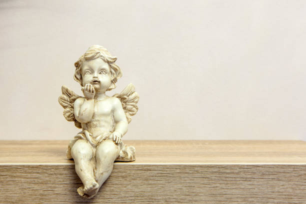 Angel figure on book shelf with copyspace stock photo