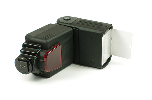 External DSLR photo camera flash called speedlight on the white background