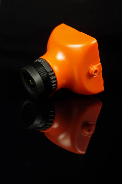 istock Small FPV drone camera isolated on the black background 957849768
