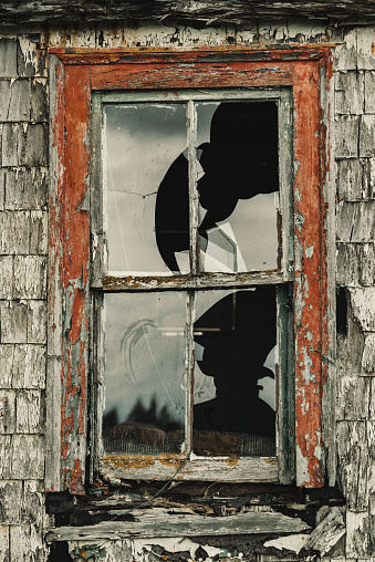 Broken window of an abandoned home.