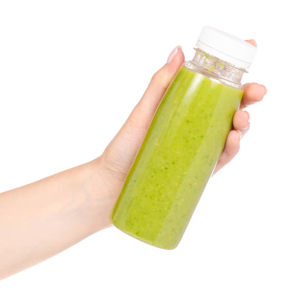 istock Bottle of smoothies green in hand 957852234