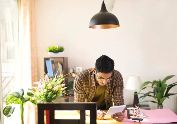 Photo of Design professional using digital tablet at desk