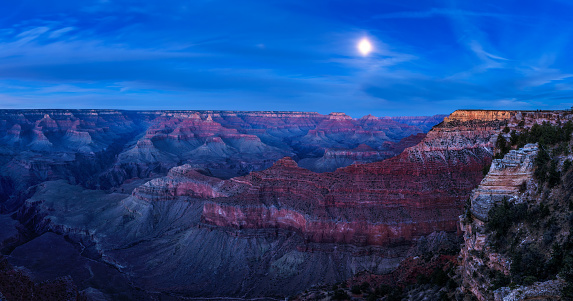 Panorama of night sky with full moon over the south rim of the Grand Canyon National Park