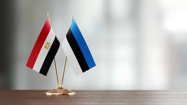 istock Egyptian And Estonian Flag Pair On A Desk Over Defocused Background 957860478