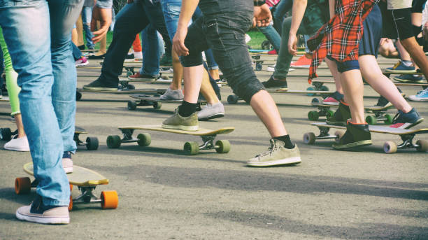 istock People skating longboards and skateboards 957860570