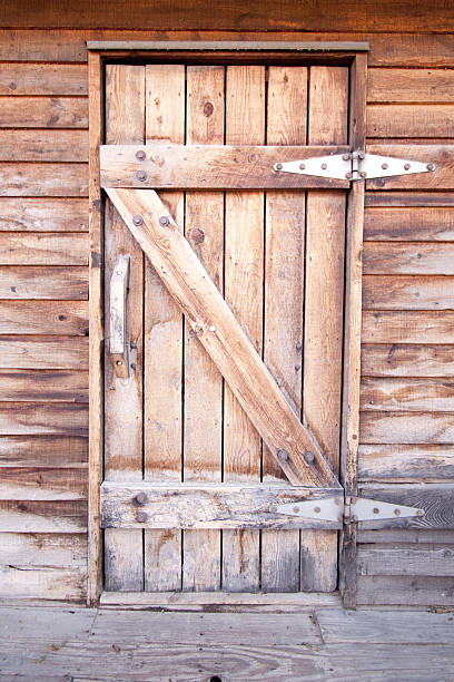 Detailed full-frame view of the side of an abandoned wooden barn exposed to the elements built originally in the 1890s.  This naturally weathered wood provides a great background.