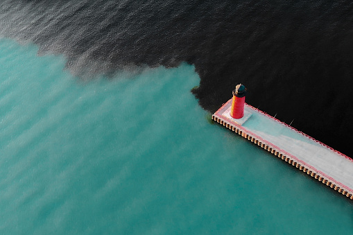 Aerial view of lighthouse. Industrial water pollution. Pier Head Light in  Milwaukee, Wisconsin, USA.  Ocean, sea, bay.