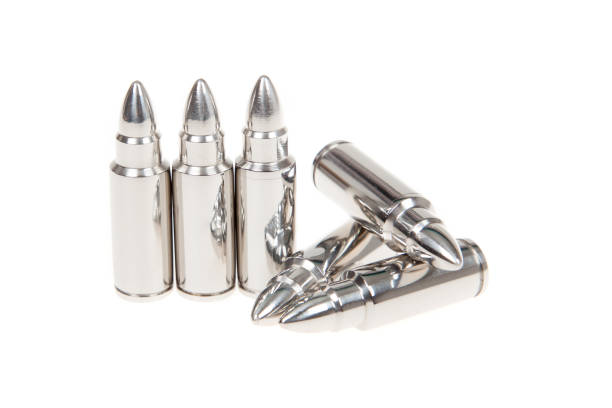 Close up of silver bullets in a row, isolated on white Close up of silver bullets in a row, isolated on white Silver Bullet stock pictures, royalty-free photos & images