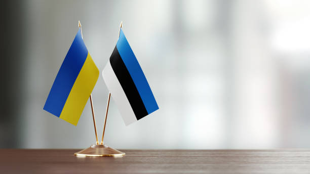 istock Ukrainian And Estonian Flag Pair On A Desk Over Defocused Background 957865166