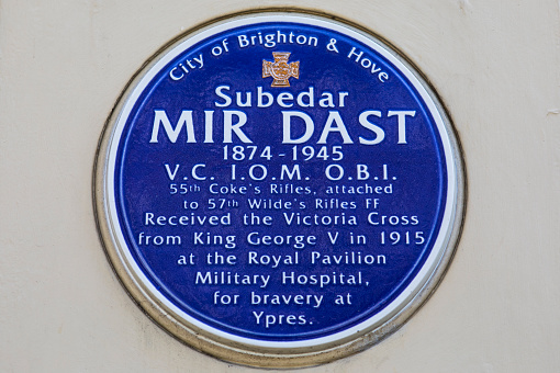 BRIGHTON, UK - MAY 4TH 2018: A blue plaque located at the Royal Pavilion in Brighton, commemorating where Subedar Mir Dast received the Victoria Cross from George V, for bravery in the Great War, taken on 4th May 2018.