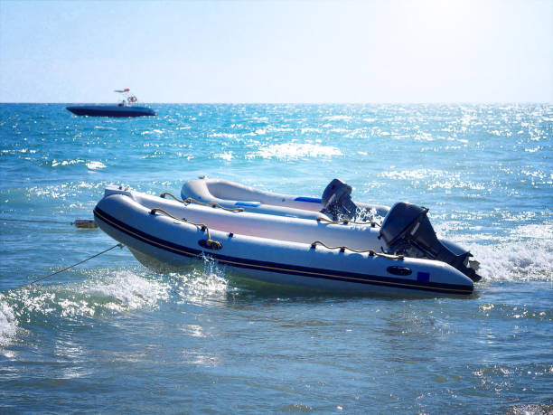 istock two inflatable boats with motors on a water 957870864