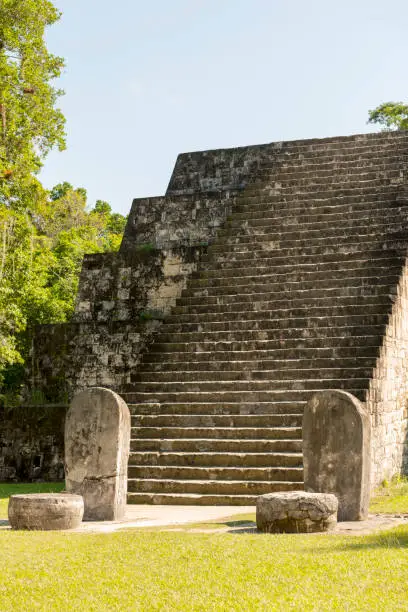 Pyramid and stele in the Complex Q area of the Mayan ruins at Tikal, Guatemala