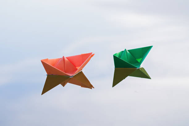 istock Colorful paper ships in the water 957876562