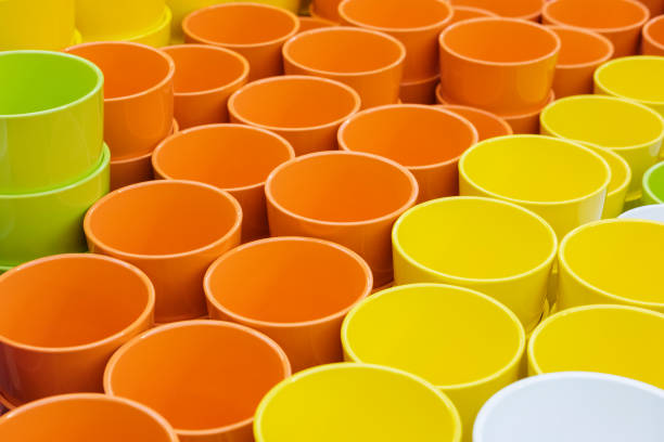 istock multi-colored flower pots of round shape on the table 957883564